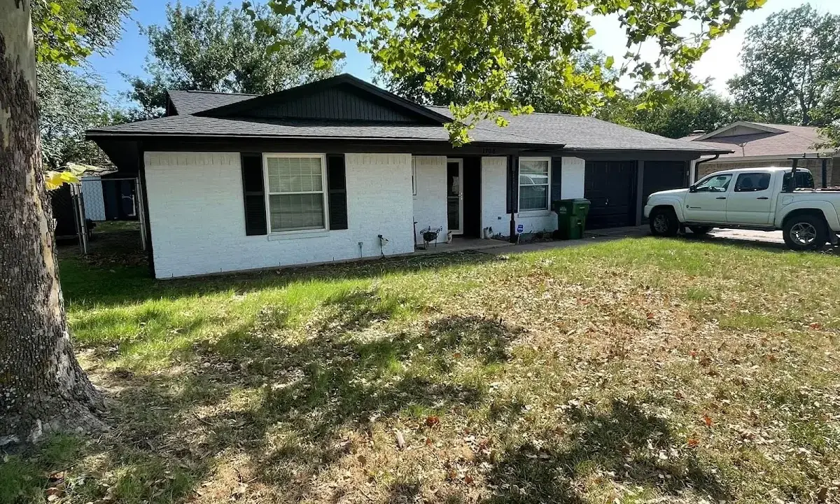 Professional roofing crew working on a residential roof in Woodmere